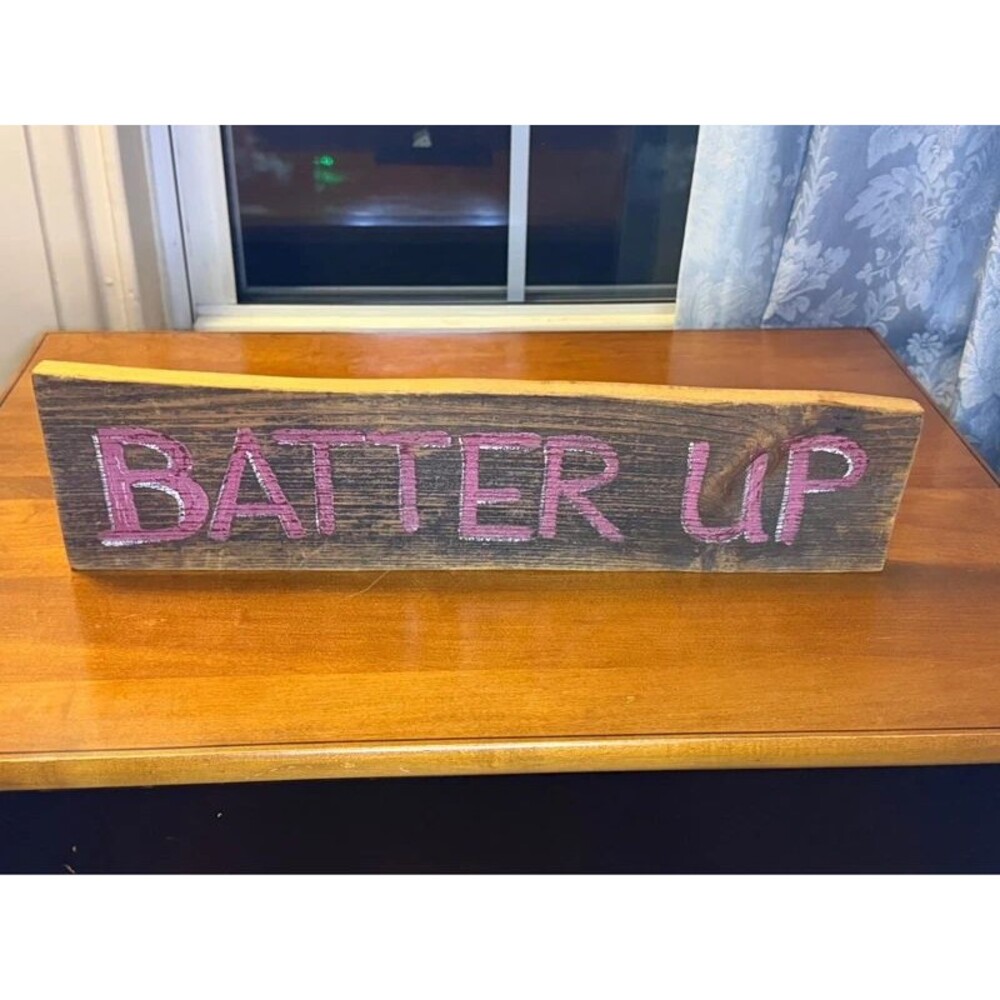 Wooden sign with the words 'Batter UP' in pink glitter
